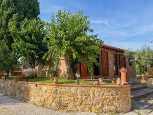 a stone retaining wall in front of a house at Podere Tre Berte - The Sleeping Beauty in Acquaviva