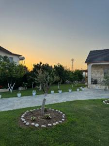a tree in a circle in the middle of a yard at N'Gjaci Guest House in Tale