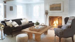 a living room with a couch and a fireplace at The Inn at GrayBarns in Norwalk
