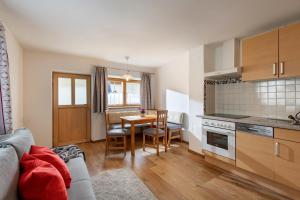 a kitchen and dining room with a table and chairs at Haus Enzian in Thiersee