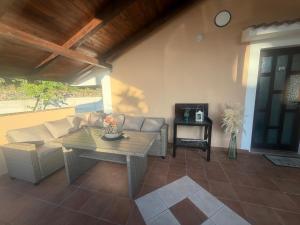 a living room with a couch and a table at Apartman Lida in Marčelji