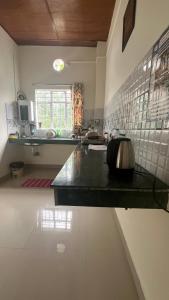 a kitchen with a counter with a sink in it at Kusum Nest in Shillong