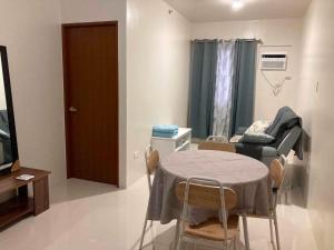a room with a table and chairs and a couch at Linear Space at Soleia Butuan Unit G in Butuan