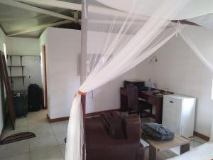 a living room with a bed and a desk at Mara Son Camp in Maasai Mara National Reserve