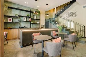 a restaurant with tables and chairs and a staircase at The Three Doors in St. Julianʼs
