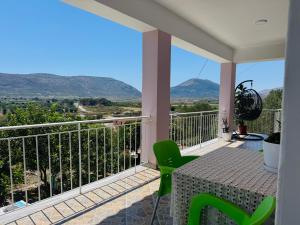 a balcony with a table and chairs and mountains at Villa Kalo in Blerimas