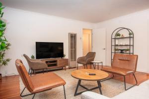 a living room with a tv and chairs and a table at Anderson Valley Inn in Philo