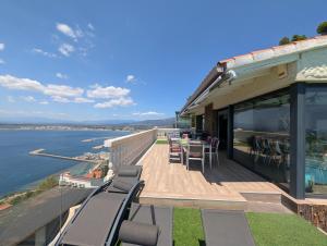 a house with a deck with a view of the water at GMID IMMO A228 Casa Unica in Roses +49 photos