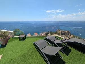 two chairs sitting on a lawn with a view at GMID IMMO A228 Casa Unica in Roses