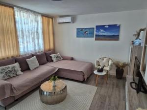 a living room with a couch and a coffee table at Apartman Sanja in Ploče