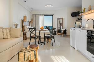 a living room with a couch and a table with chairs at Gaia-Castle vista in Monemvasia