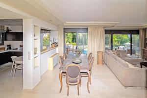 a dining room and living room with a table and chairs at Azure Villa Kanoni in Análipsis