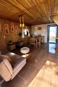 a living room with a couch and a table at Cabanas Brisa da Lagoa in Arroio do Silva