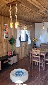 a living room with a table and a dining room at Cabanas Brisa da Lagoa in Arroio do Silva +14 photos