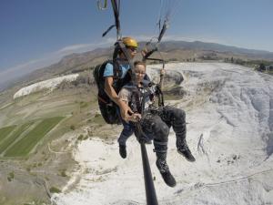 two people hanging from a rope in a zip line at Ozbay Hotel in Pamukkale