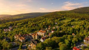 an aerial view of a town in a forest at Santa Christina Mountain Resort in Świeradów-Zdrój