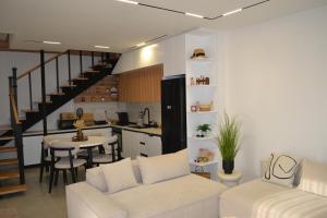 a living room with a couch and a table and a kitchen at Vila 18 in Velipojë