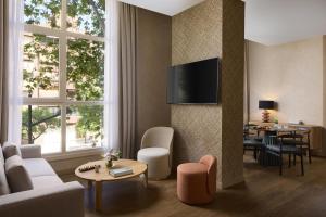 a living room with a couch and a table at NH Valencia Center in Valencia