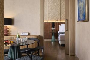 a hotel room with a table and a bed at NH Valencia Center in Valencia