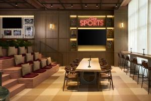 a restaurant with a table and chairs and a tv at NH Valencia Center in Valencia +47 photos
