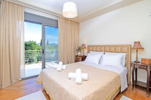 a bedroom with a bed with two candles on it at Azure Villa Kanoni in Análipsis +24 photos