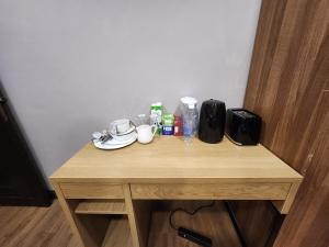 a small wooden table with cups and other items on it at Prime's Home in Nevendon +13 photos