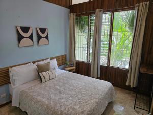 a bedroom with a bed and a large window at casa luca in San José +57 photos