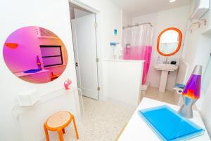 a bathroom with a mirror and a sink and a table at Sunset Inn and Cabanas in St. Pete Beach +24 photos
