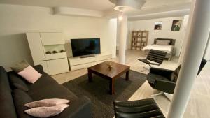 a living room with a couch and a television at Wohnatelier Calw in Calw