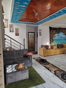 a living room with two couches and a ceiling at FERME Mama Aïcha in Kenitra