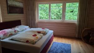 two twin beds in a room with two windows at Schwedenhaus Eichenberg in Eichenberg