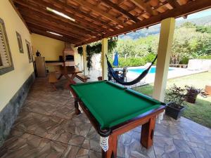 a pool table on the patio of a house at Chácara Mative Socorro SP in Socorro