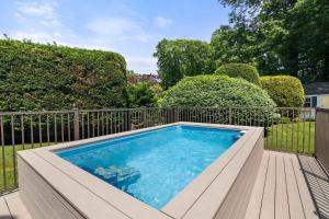 a small swimming pool with a fence and trees at Heated Plunge Pool Theater Room Backyard Fun in Orleans