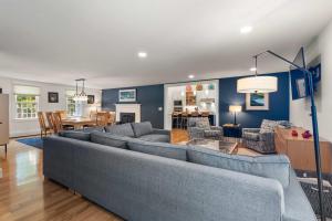 a living room with a couch and a dining room at Heated Plunge Pool Theater Room Backyard Fun in Orleans +35 photos