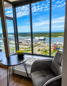 a living room with a couch and a table at UP 34 FLOOR APARTMENTS in Klaipėda