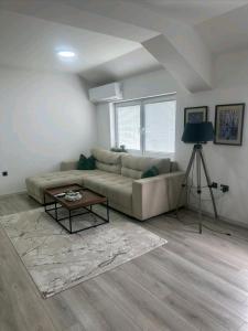 a living room with a couch and a table at Apartman Centar-moderan dvosoban stan u centru in Priboj