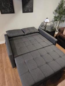 a black couch sitting in a living room at Guest house in Shawinigan