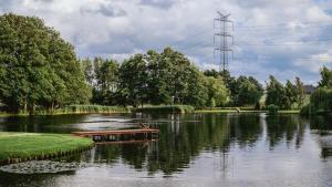 a boat in the middle of a river at Domki w Parku in Pępowo