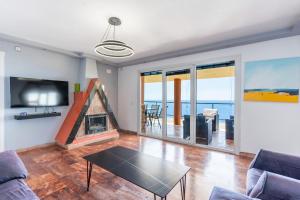 a living room with a couch and a fireplace at Villa Infinity I Sea Views I Saltwater Pool I Jacuzzi I BBQ in Almería