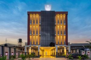 a building with a clock on top of it at BON Hotel Emporium in Ughelli