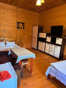 a room with a tv and a table in a room at Садиба Каньйон in Kamianets-Podilskyi