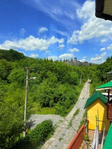 a train traveling down a dirt road through a forest at Садиба Каньйон in Kamianets-Podilskyi