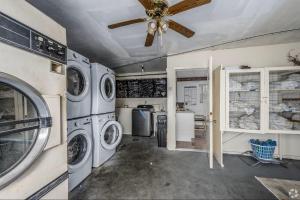 a laundry room with washing machines and a ceiling fan at Lumina Motel in Daytona Beach