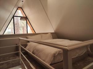 a bed in a small room with a window at كوخ ساره سبيشل دورين in Al-ʿUla