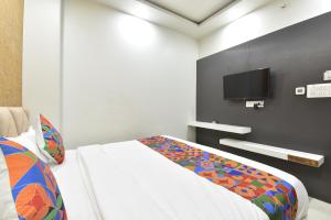 a bedroom with a bed and a flat screen tv at Hotel Pearl Heritage in Jaipur +62 photos