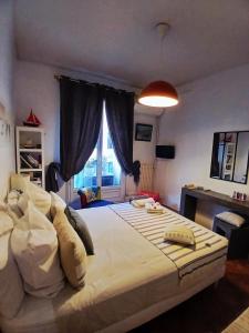 a bedroom with a large bed and a window at Chambre au panier in Marseille