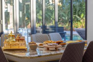 a table with a tray of food on top at Villa Horizon Marrakech in Marrakesh