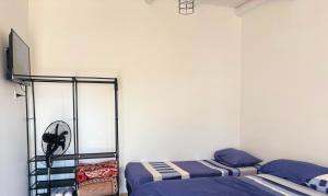 a bedroom with two beds and a white wall at Tu lugar de descanso III in Federación