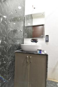 a bathroom with a sink and a counter with a mirror at Hotel Pearl Heritage in Jaipur