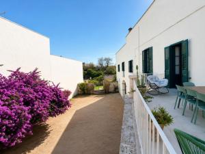 a courtyard of a house with purple flowers at Palazzo Vite in Copertino
